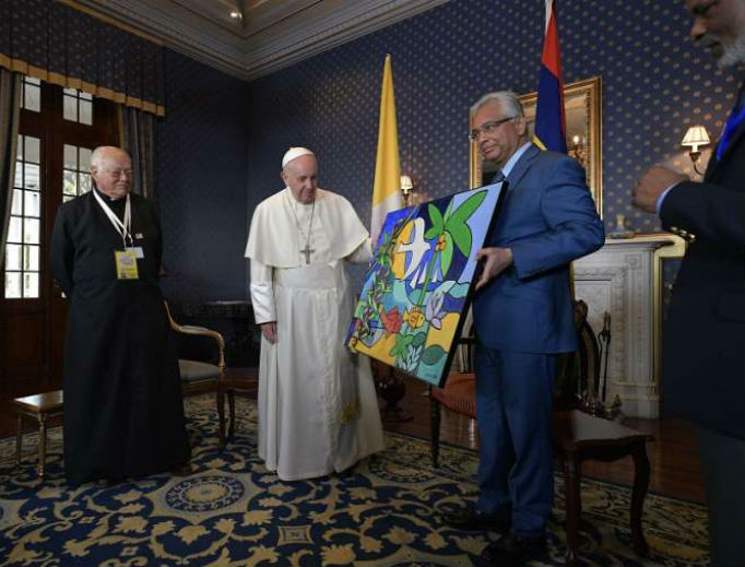 Pope Francis receives a gift from acting president of Mauritius Barlen Vyapoory Sept. 9.