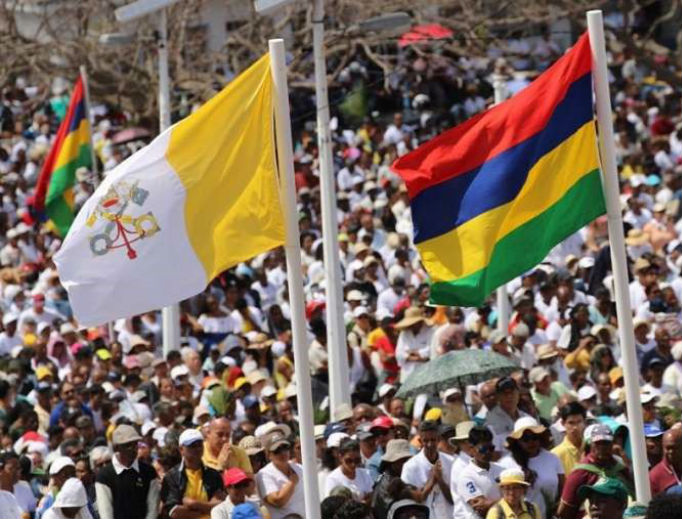 People wave flags during Mass with Pope Francis in Port Louis, Mauritius, Sept. 9.