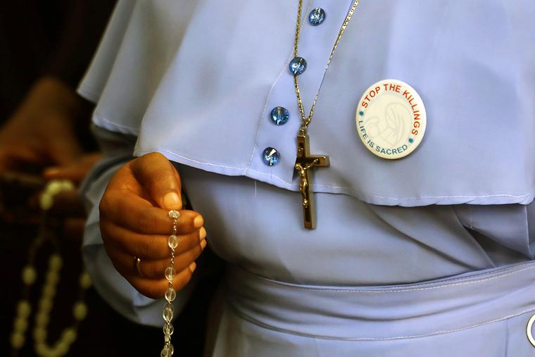 A Catholic sister holding a rosary attends a march on the streets of Abuja, Nigeria, on March 1, 2020, after the Catholic bishops of that nation called for prayer and penance for peace and protection against the murder and kidnapping of Christians by the Boko Haram insurgents.