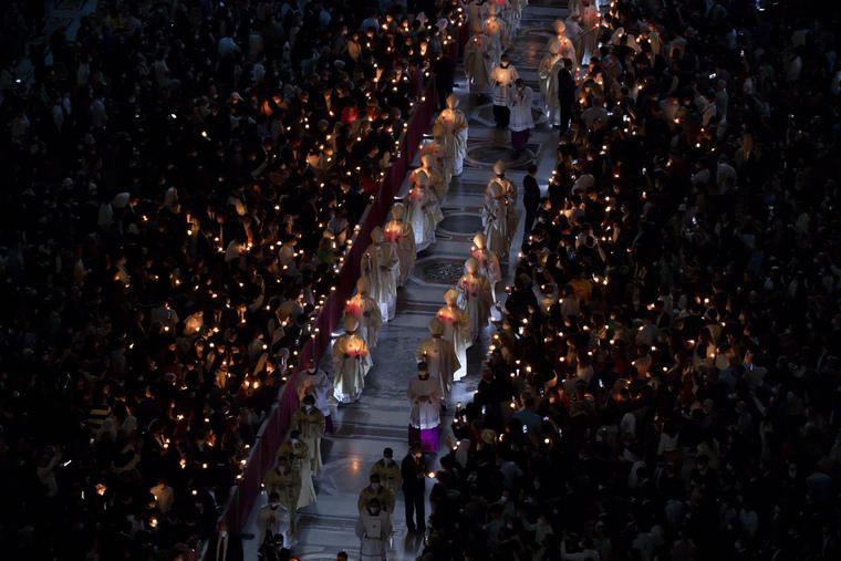 Candles flicker in St. Peter’s Basilica at the Vatican for the Easter vigil 2022 on April 16.