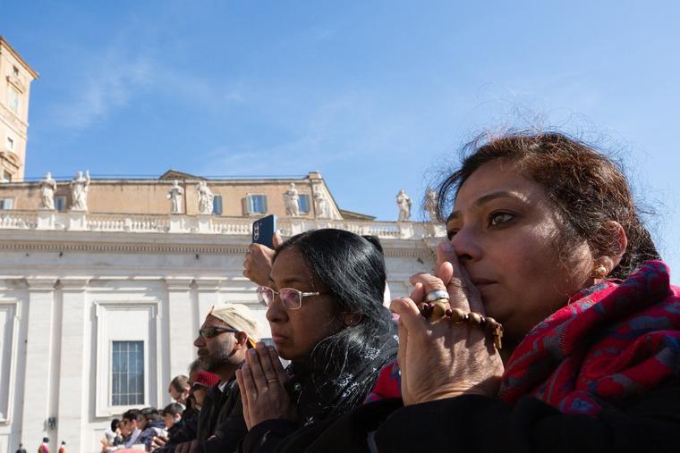 Women pray in St. Peter’s Square during Pope Francis’ April 12 general audience. 