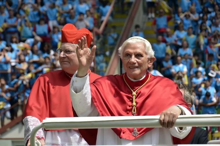 Pope Benedict XVI waves at the World Family Meeting in Milan with Cardinal Angelo Scola on June 4, 2012.