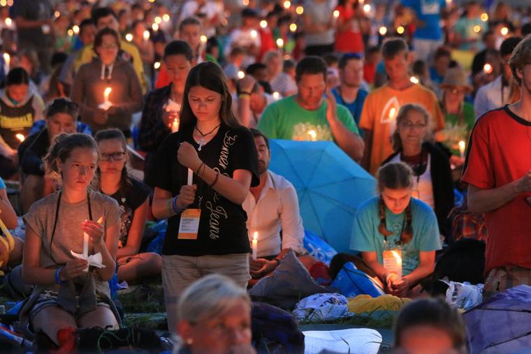 Pilgrims pray by candlelight at Campus Misericordiae in Krakow, Poland, for World Youth Day on July 30, 2016.
