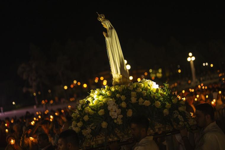 A statue of Our Lady of Fatima is carried during a Rosary and Candle procession at the Our Lady of Fatima shrine, in Fatima, central Portugal, Friday, Aug. 4, 2023. 