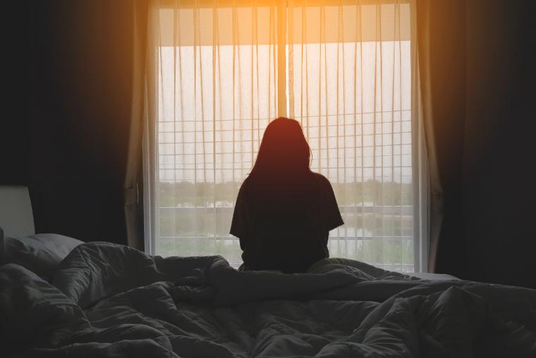 Woman sitting alone inside her home.