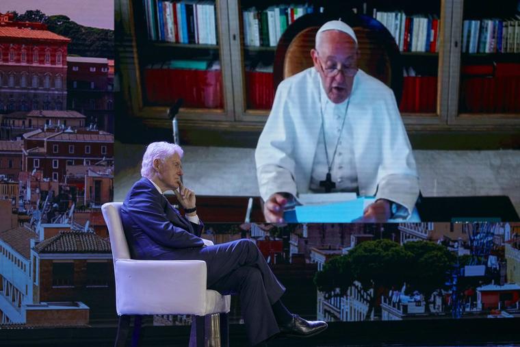 Pope Francis, seen on a screen, right, speaks with former President Bill Clinton, left, through video conference during the Clinton Global Initiative, Monday, Sept. 18, 2023 in New York. 