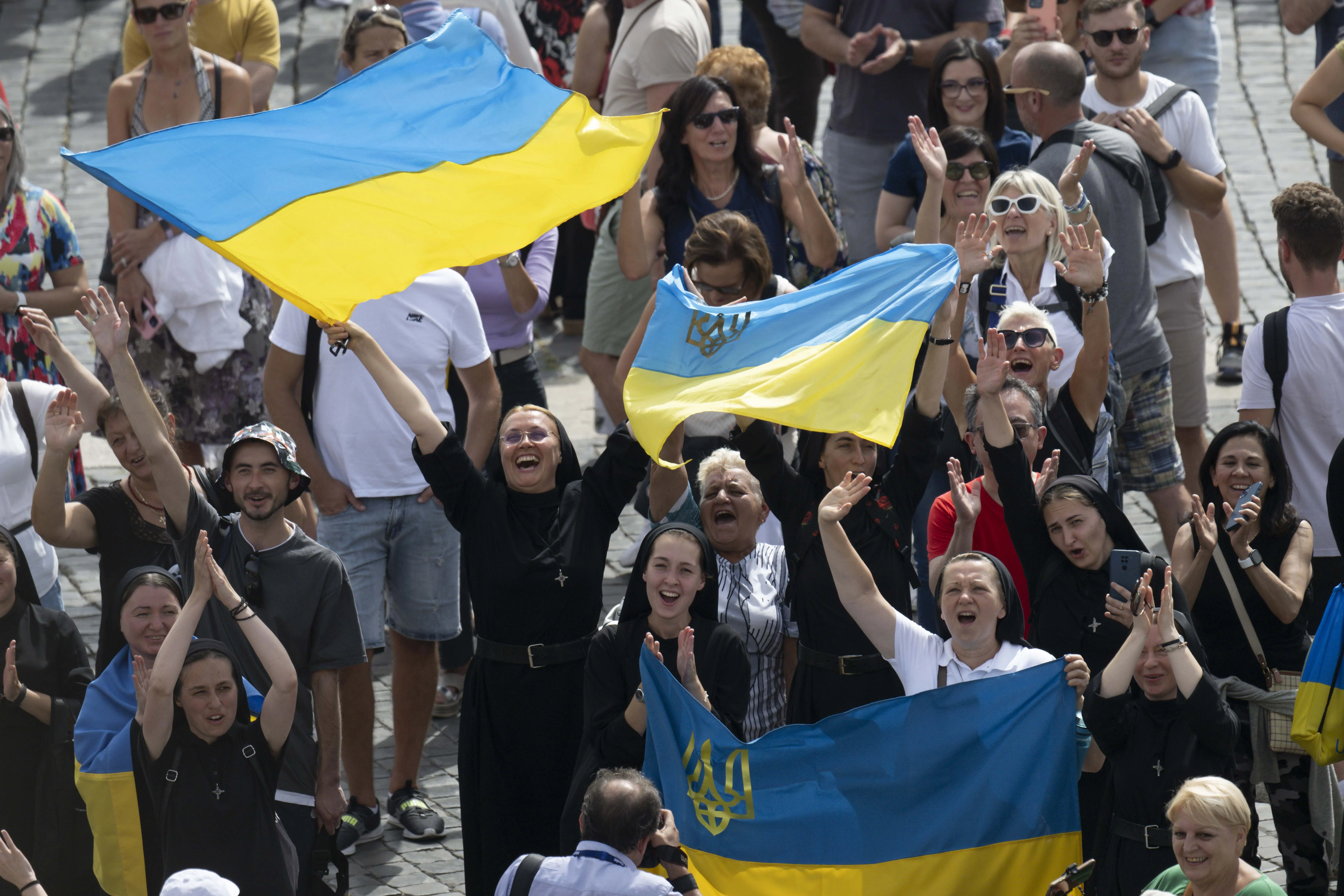 Ukrainian Catholics wave to the pope during his Sunday Angelus address on Sept. 17, 2023. Vatican Media