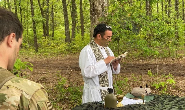 Camouflage and Sacraments. Father Pomposello offers Mass during a month-long field training exercise at Fort Campbell, KY Summer 2021.